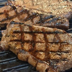 indoor grilled steak on a grill pan, showing cross marks, juicy texture